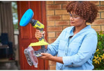 Load image into Gallery viewer, Person using a power washer with a blue nozzle in front of a brick wall.