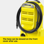 Load image into Gallery viewer, Yellow Kärcher pressure washer with a coiled black hose on a light gray background, with a yellow text banner at the bottom stating 'The hose can be stowed on the front cover after use.'.