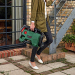 Load image into Gallery viewer, Person holding a green and black Bosch power tool outdoors.
