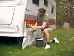 Load image into Gallery viewer, Man cleaning a caravan with a brush and bucket on grass