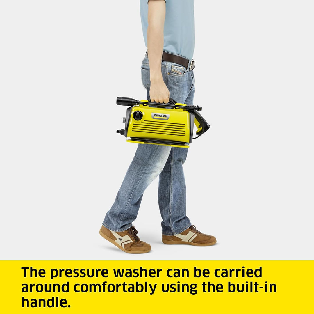A person in jeans and a light blue shirt carries a yellow and black Kärcher pressure washer by its built-in handle, shown against a light gray background with a yellow text banner at the bottom.