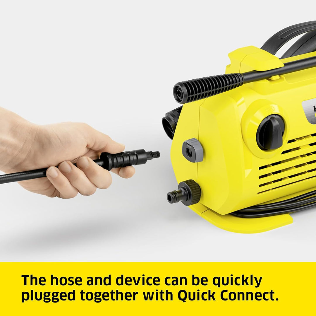 Yellow pressure washer with a hand plugging in a black hose on a white background