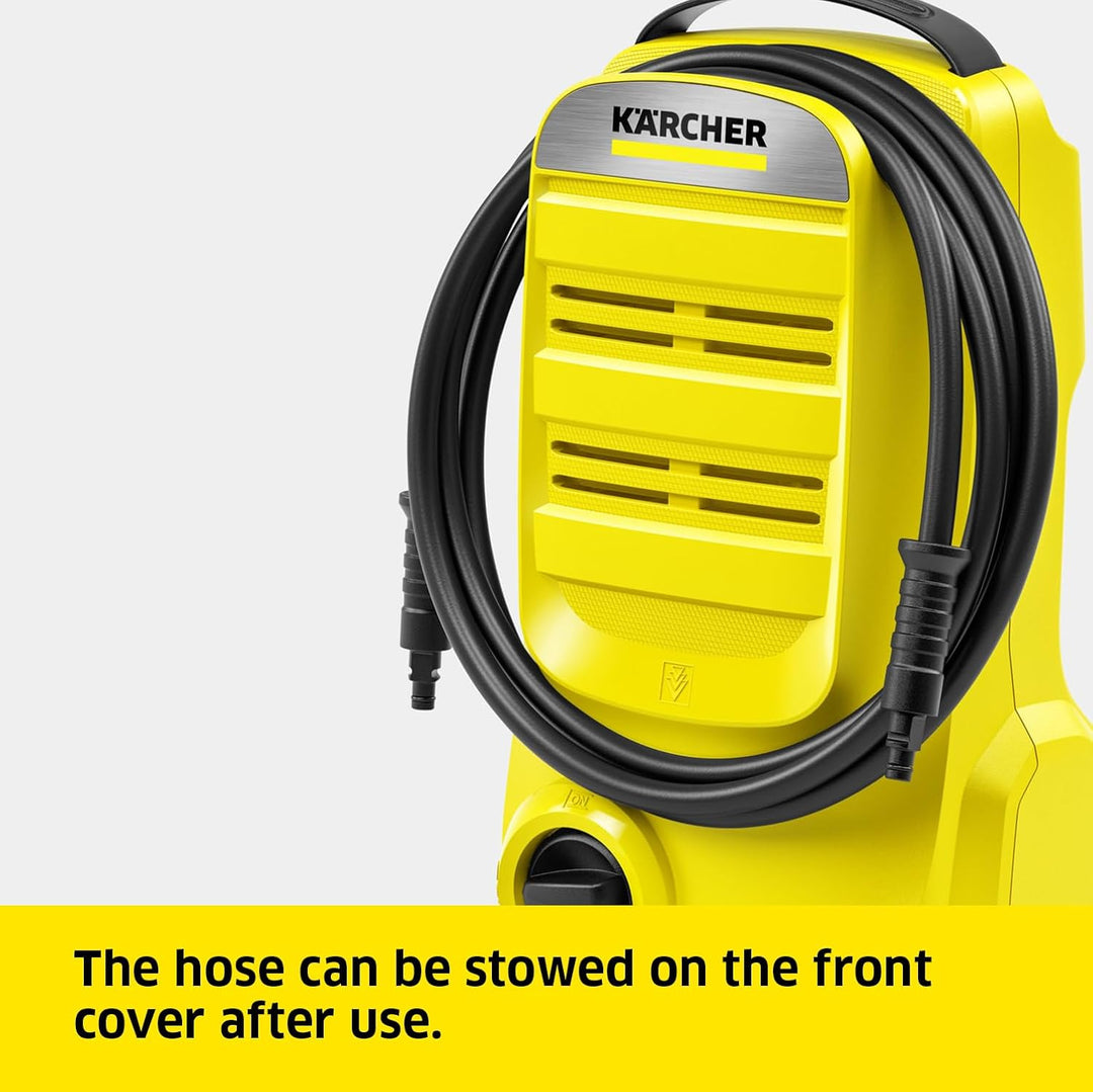 Yellow Kärcher pressure washer with a coiled black hose on a light gray background, with a yellow text banner at the bottom stating 'The hose can be stowed on the front cover after use.'.