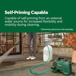 Load image into Gallery viewer, Person using a pressure washer with a self-priming attachment on a wooden deck.