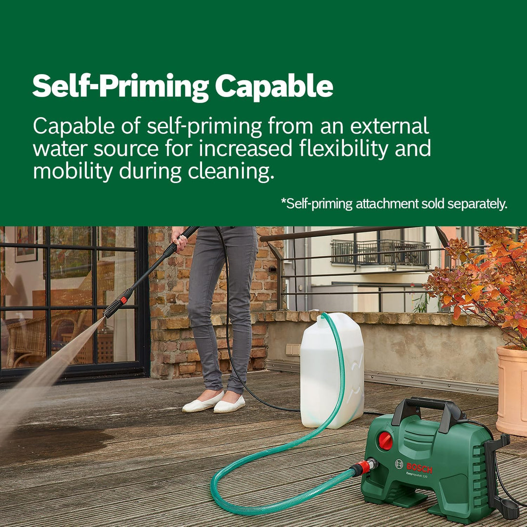 Person using a pressure washer with a self-priming attachment on a wooden deck.